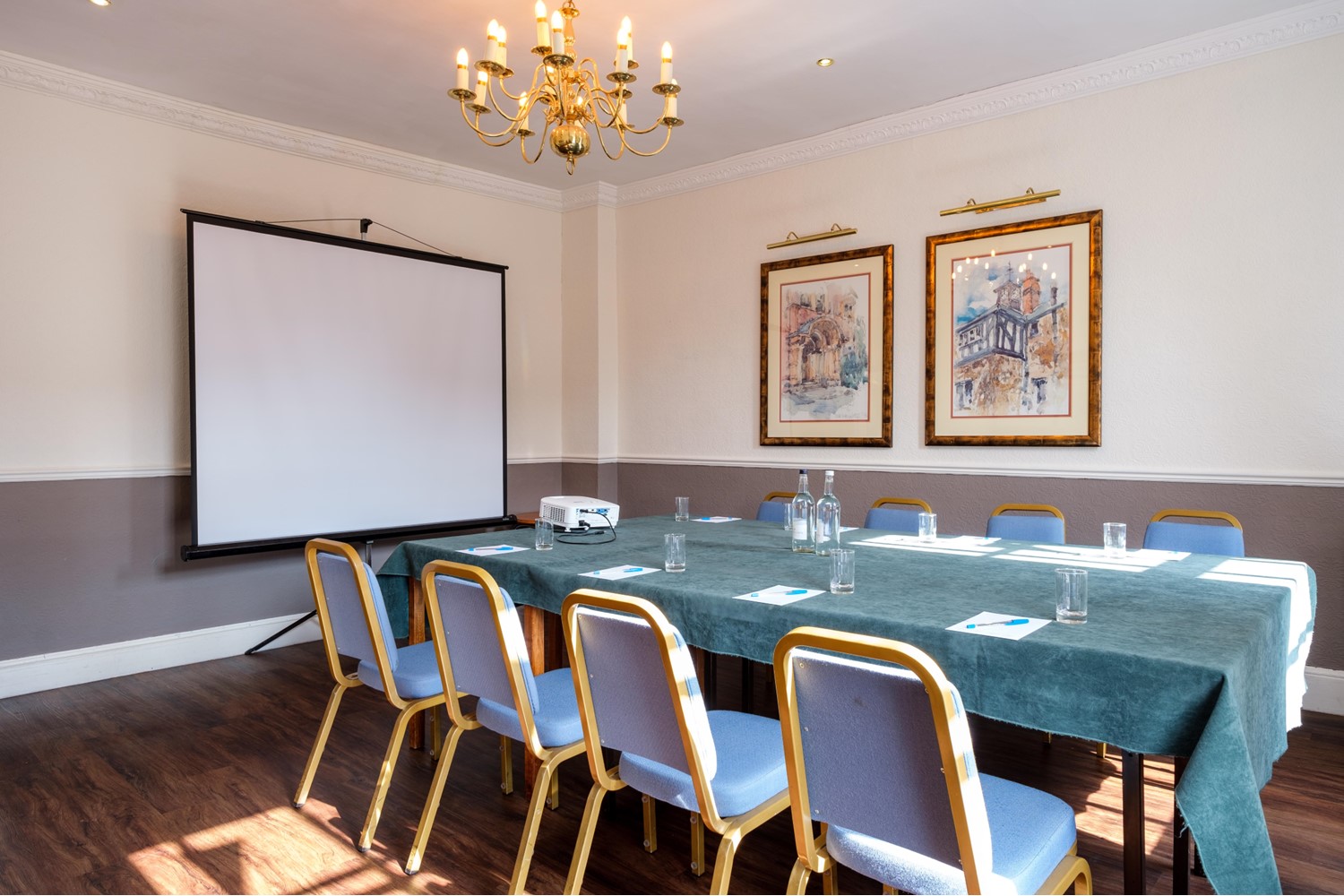 The Johnson Room arranged around a meeting table with a projection screen.