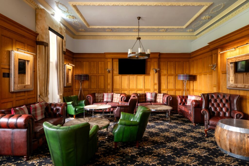 Oak-panelled Ladywood room with leather seating and low tables