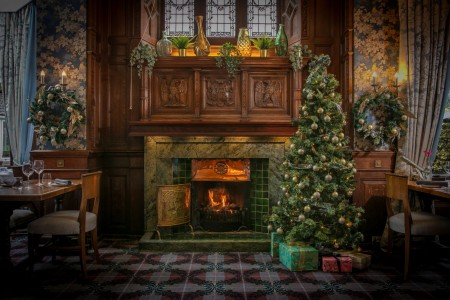 Christmas tree beside the fireplace in The Oak Room Brasserie