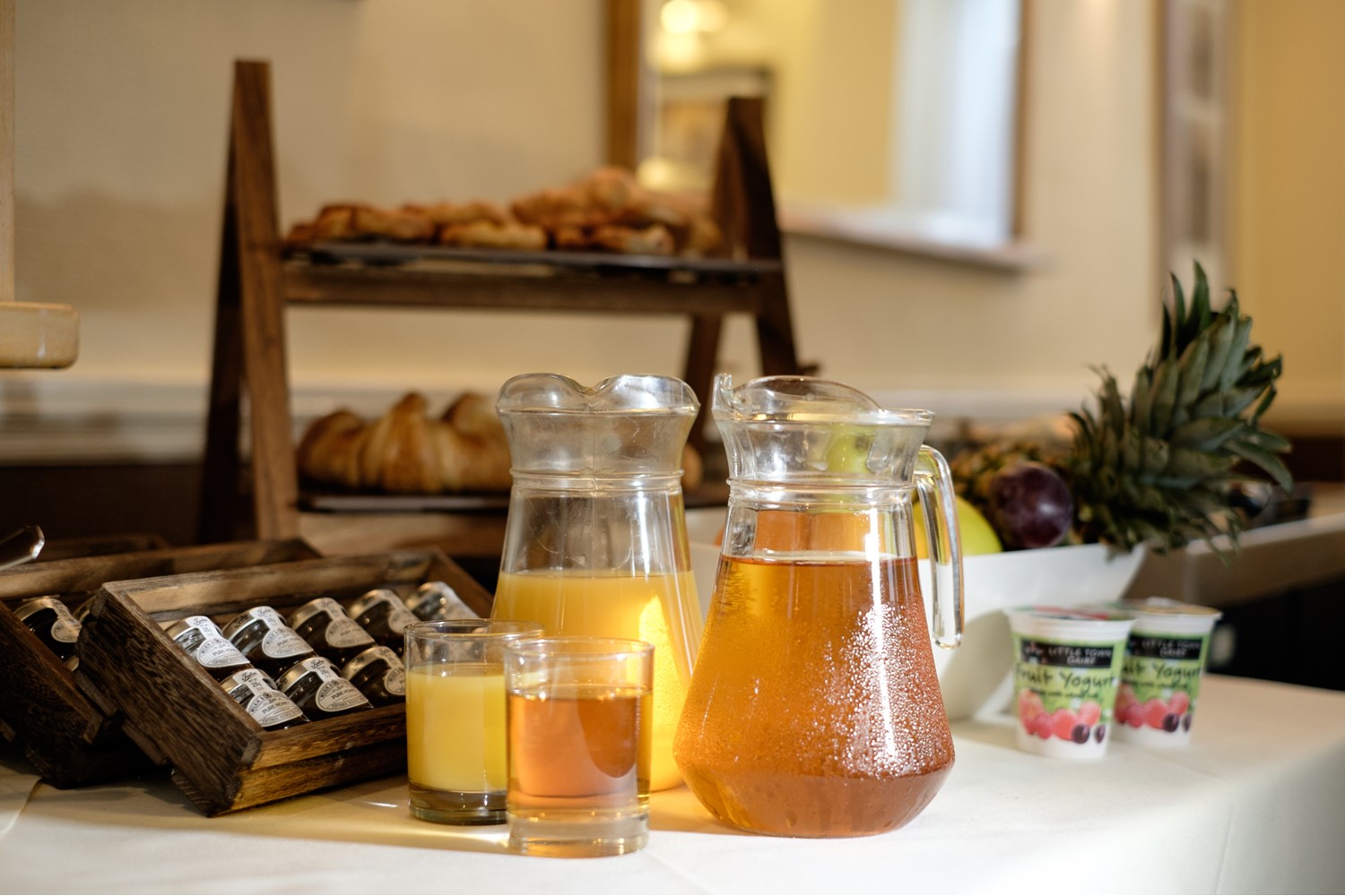Breakfast buffet with juice, cereal and pastries