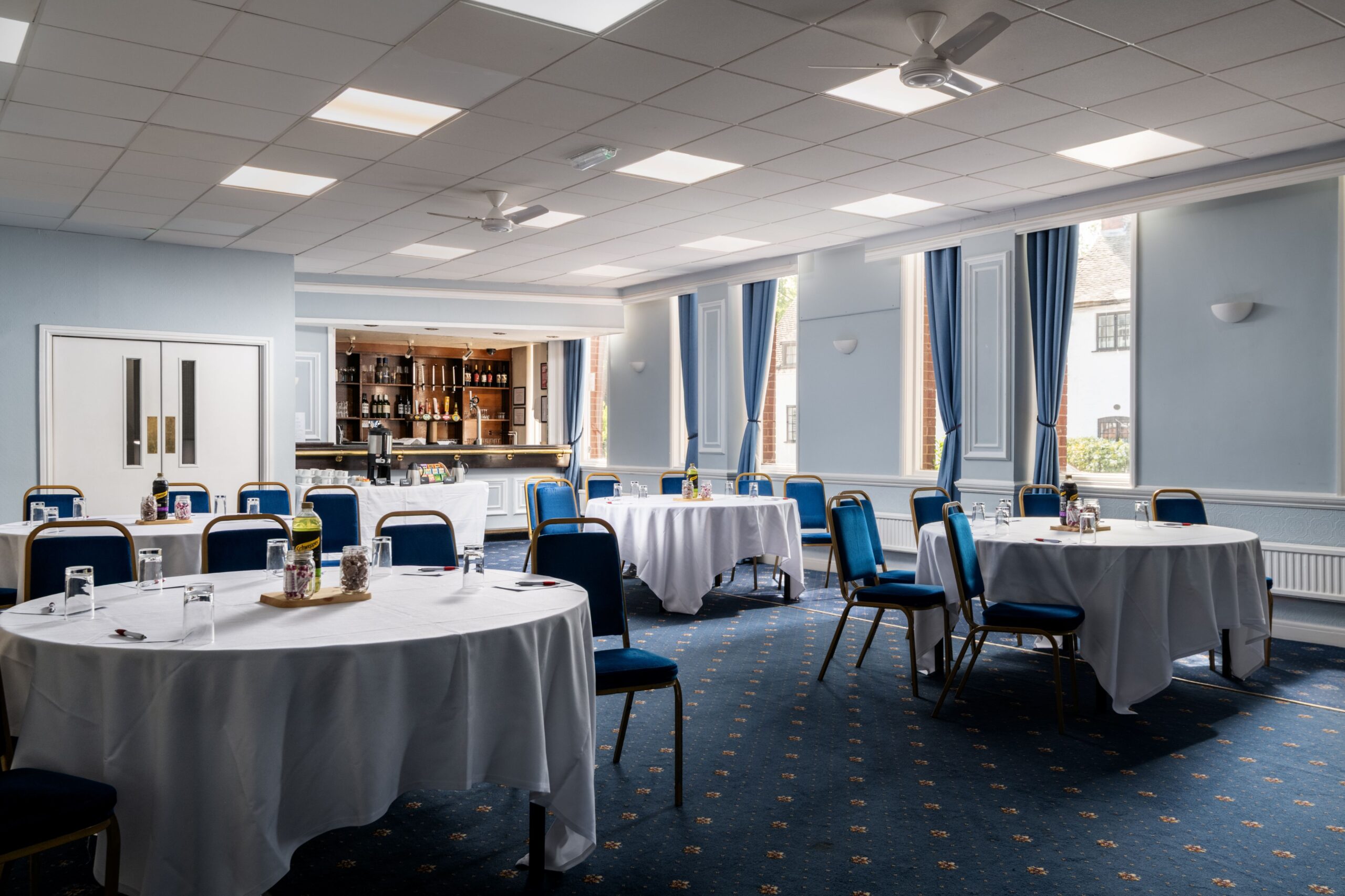 Round tables set for a meeting in the Lichfield Suite